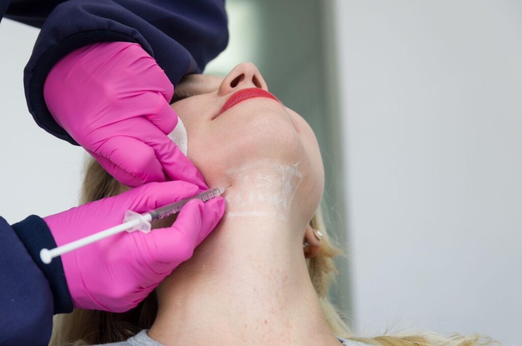 Kybella treatment session in progress for double chin reduction.