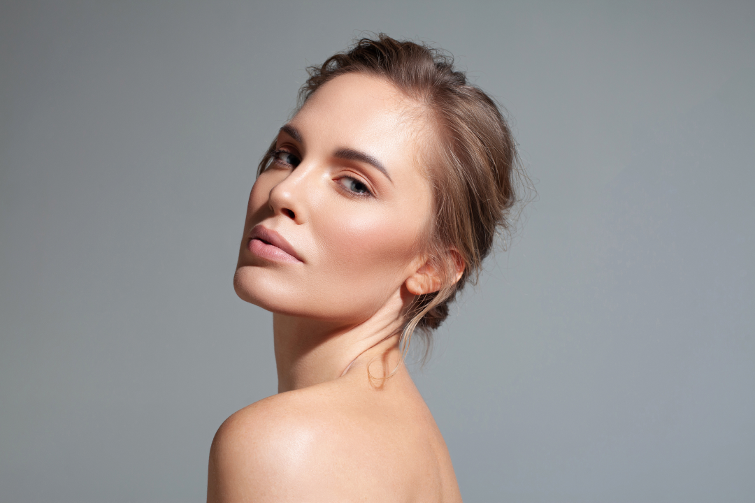 A woman with smooth, radiant skin after receiving dermal fillers for facial enhancement.