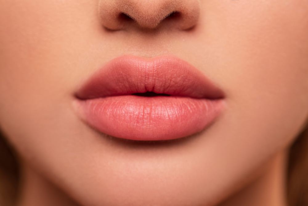 Close-up of plump lips enhanced with lip fillers.